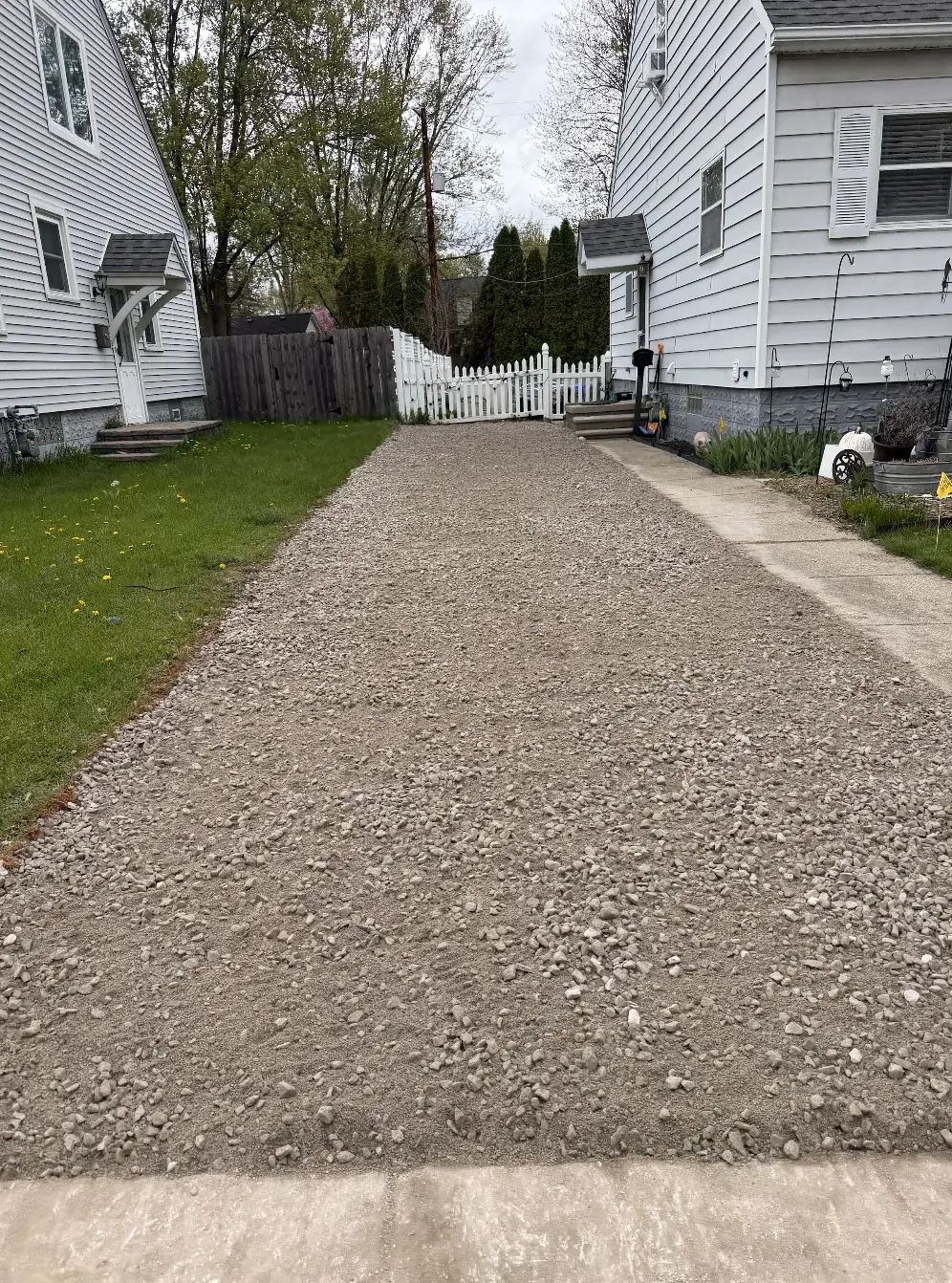 Finished gravel driveway between two houses