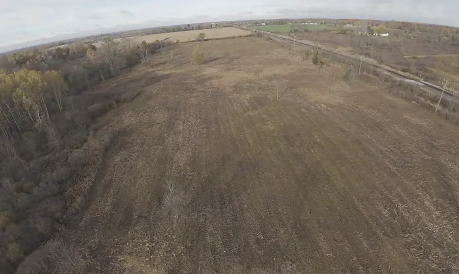 Aerial view of a large overgrown field mulched back to open ground
