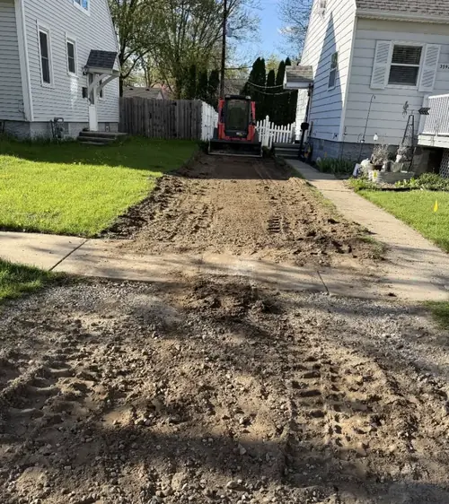 Side yard and drive dug out beside a house during regrading