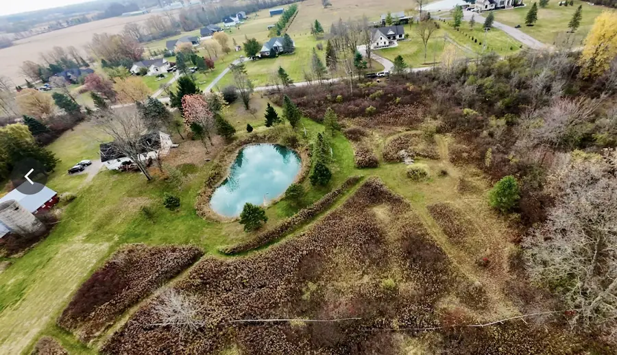 Before: Several acres of overgrown ground around a pond, mulched and cleared back to open, usable field.