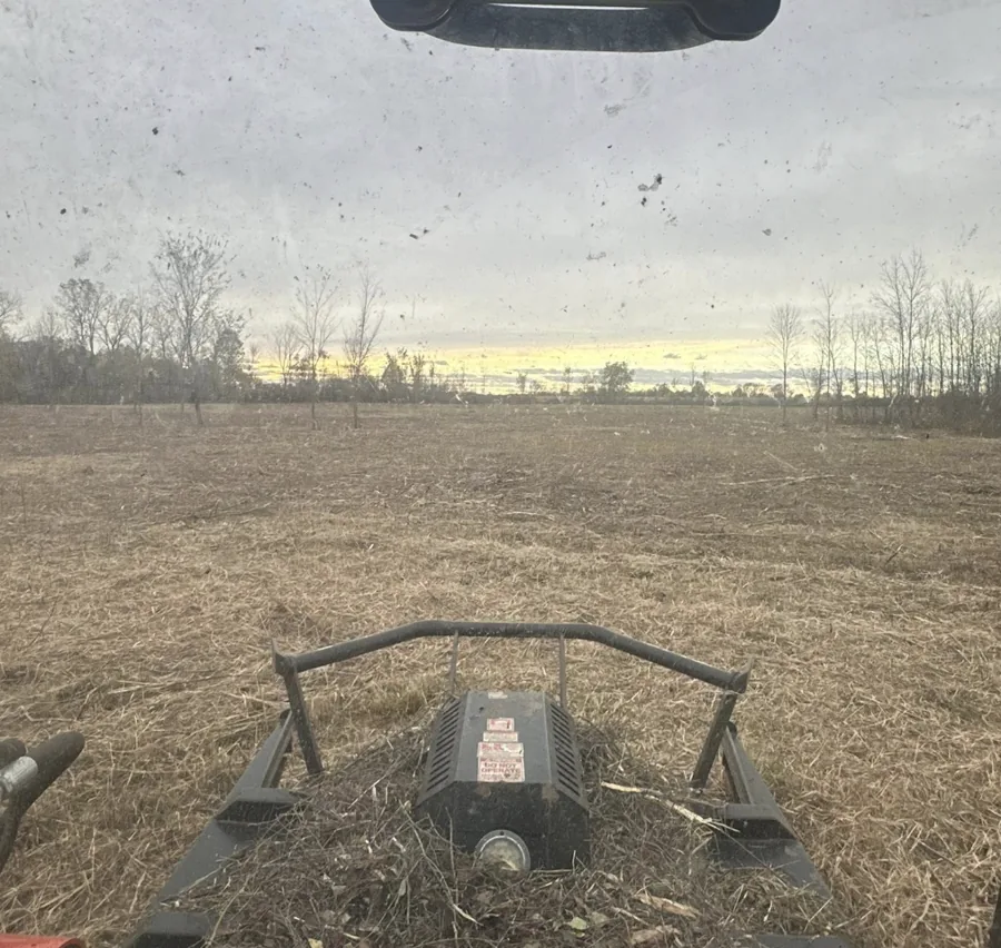 Mulching head working across an overgrown field